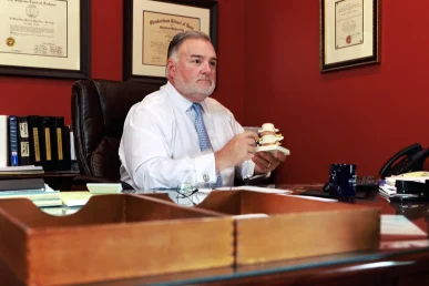 Attorney joel hamner discusses a ups accident exhibit with a client, highlighting delivery route details.