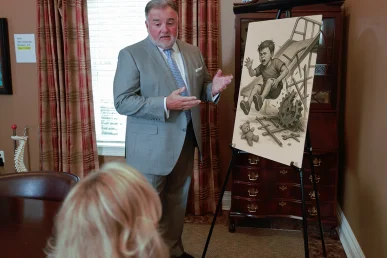 Attorney joel hamner discusses a concussion and tbi exhibit with a client, pointing to medical imaging evidence.