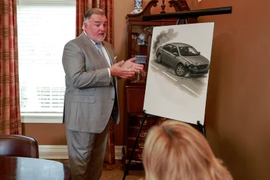 Attorney joel hamner discusses a defective tire exhibit with a client, noting tread separation evidence.