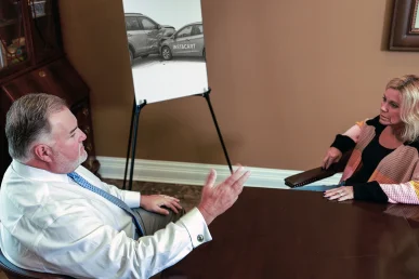 Attorney joel hamner discusses an instacart accident exhibit with a client, including delivery route maps.