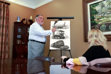 Attorney joel hamner discusses an other vehicle accidents exhibit with a client, covering unusual crash scenarios.