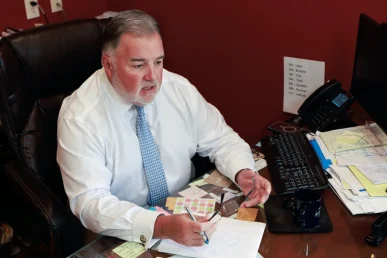 Attorney joel hamner explains a big rig accident exhibit to a client, showing highway crash analysis.
