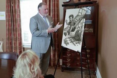 Attorney joel hamner explains a child injury exhibit to a client, featuring playground safety analyses.