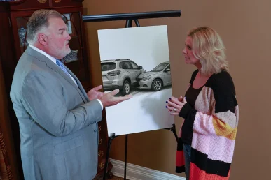 Attorney joel hamner explains a fender bender exhibit to a client, highlighting minor collision details.