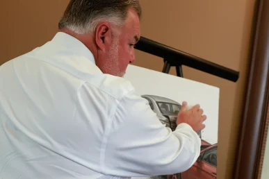 Attorney joel hamner explains a speeding accident exhibit to a client, presenting radar gun readings.