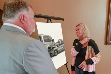 Attorney joel hamner meets with a client to discuss a grubhub accident exhibit showing driver route data.