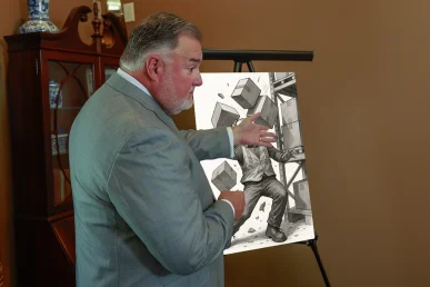 Attorney joel hamner meets with a client to discuss a falling object accident exhibit highlighting workplace safety lapses.
