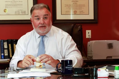 Attorney joel hamner meets with a client to discuss a slip and fall exhibit showing security camera stills.