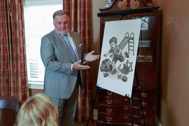 Attorney joel hamner meets with a client to review a day care accident exhibit featuring safety inspection details.