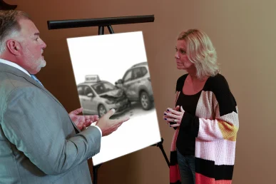 Attorney joel hamner presents a food delivery accident exhibit to a client, showing gps and route analysis.