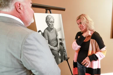 Attorney joel hamner presents a nursing home exhibit to a client, documenting neglect and staffing records.