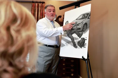 Attorney joel hamner presents a pedestrian accident exhibit to a client, showing crosswalk signal timing.