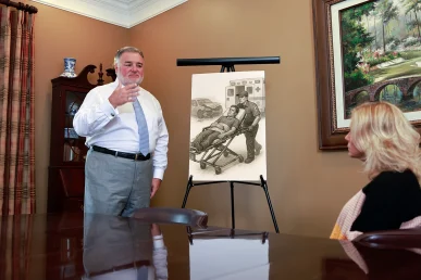Attorney joel hamner presents an organ damage injury exhibit to a client, highlighting medical imaging evidence.