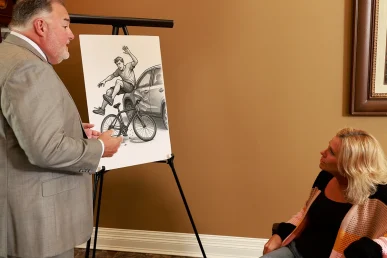 Attorney joel hamner reviews a bone fracture exhibit with a client, showing x rays and recovery timelines.