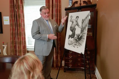 Attorney joel hamner reviews a defective staircase exhibit with a client, highlighting structural flaws.