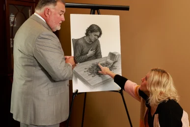 Attorney joel hamner reviews a food poisoning exhibit with a client, featuring lab results and inspection records.