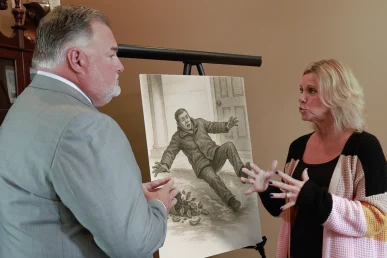 Attorney joel hamner reviews a homeowner liability exhibit with a client, noting property code violations.