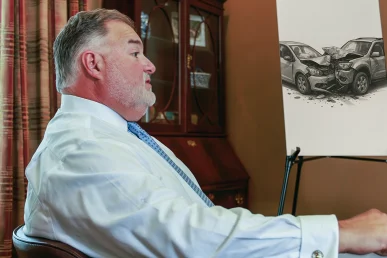 Attorney joel hamner reviews a severe injury exhibit with a client, highlighting long term care projections.