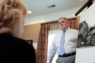 Attorney joel hamner reviews an uber eats accident exhibit with a client, highlighting delivery route information.