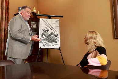 Attorney joel hamner shares a construction accident exhibit with a client, highlighting site safety violations.