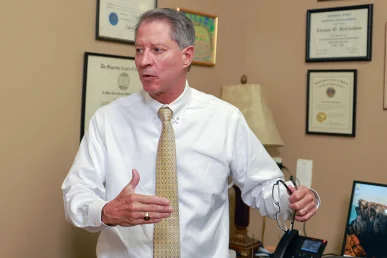 Attorneys joel hamner and tom mccutcheon consult with a client about a food delivery accident case.