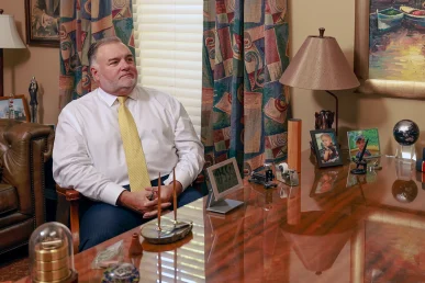 Attorneys joel hamner and tom mccutcheon consult with a client about a reckless driving accident lawsuit.