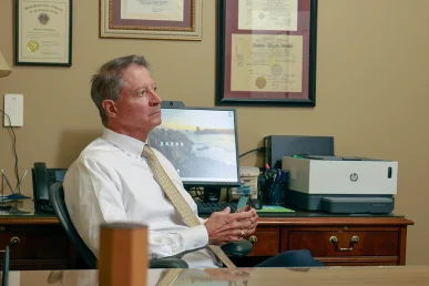 Attorneys joel hamner and tom mccutcheon consult with a client about a taxi accident lawsuit.