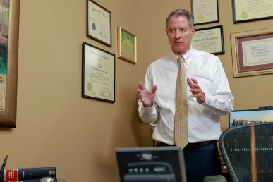 Attorneys joel hamner and tom mccutcheon consult with a client about an insurance bad faith case.