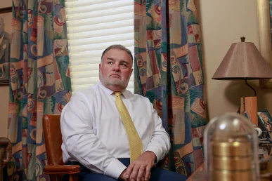 Attorneys joel hamner and tom mccutcheon discuss a speeding accident lawsuit with a client.