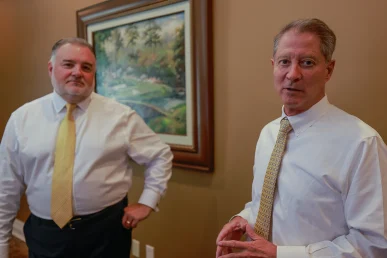 Attorneys joel hamner and tom mccutcheon evaluate aviation safety data for a helicopter crash lawsuit.