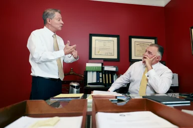 Attorneys joel hamner and tom mccutcheon investigate mechanical records for a vehicle brake malfunction lawsuit.