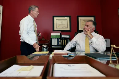 Attorneys joel hamner and tom mccutcheon plan a complex lawsuit after a highway tractor trailer collision.