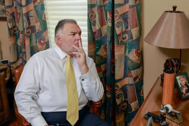 Attorneys joel hamner and tom mccutcheon talk with a client about a fedex delivery accident claim.