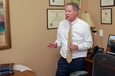 Attorneys joel hamner and tom mccutcheon talk with a client about a drowning accident case.