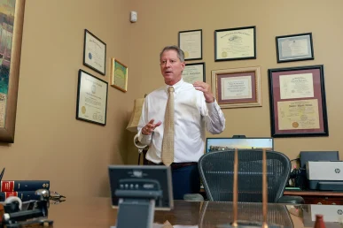 Attorneys joel hamner and tom mccutcheon talk with a client about a jogger and runner accident claim.