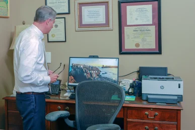 Attorneys joel hamner and tom mccutcheon talk with a client about pursuing a bicycle accident claim.