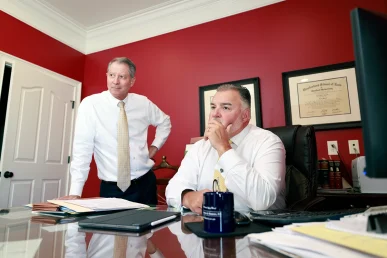 Attorneys tom mccutcheon and joel hamner consult with a client about a moving truck accident claim.