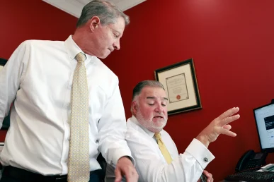 Attorneys tom mccutcheon and joel hamner consult with a client about a serious delivery truck accident claim.