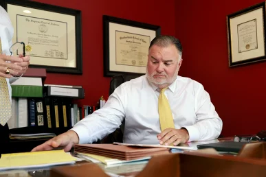 Attorneys tom mccutcheon and joel hamner consult with a client about a toxic exposure claim.
