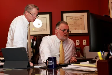 Attorneys tom mccutcheon and joel hamner consult with a client on the details of a complex big rig accident case.