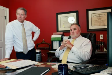 Attorneys tom mccutcheon and joel hamner meet with a client to discuss a social security disability benefits case.