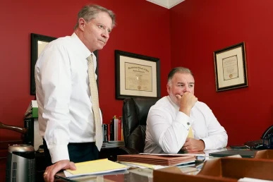 Attorneys tom mccutcheon and joel hamner meet with a client to discuss a complex nerve injury claim.