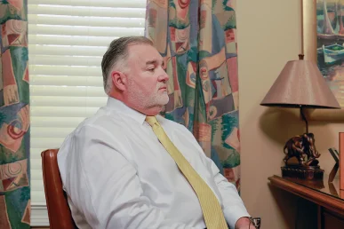 Joel hamner joins tom mccutcheon to review an airplane accident case with a client during a free consultation.