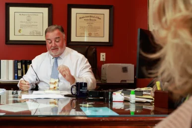 Lawyer joel hamner discusses a side swipe accident exhibit with a client, covering lane change analysis.