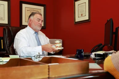 Lawyer joel hamner explains a grubhub accident exhibit to a client, covering driver route data.