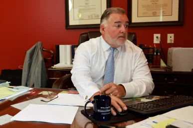 Lawyer joel hamner explains a dog bite exhibit to a client, highlighting animal control reports.