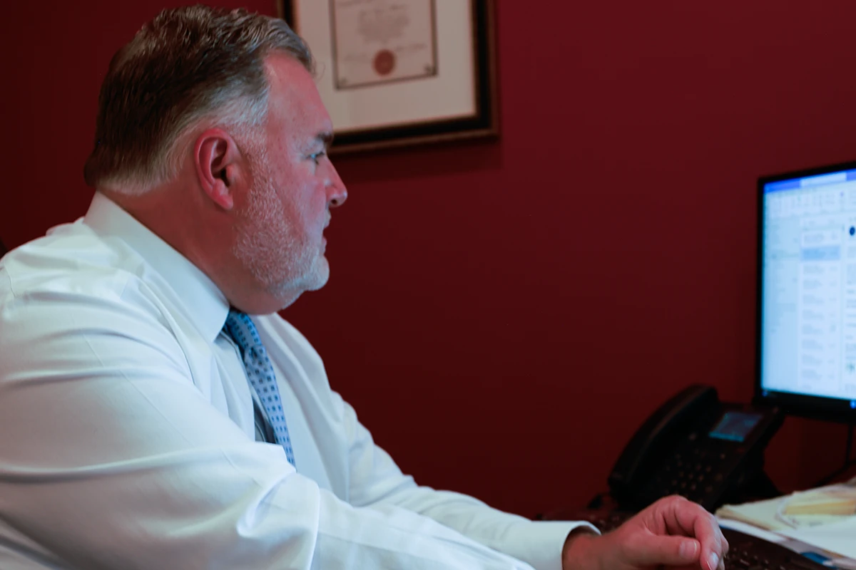 Lawyer joel hamner explains a workers’ compensation exhibit to a client, noting workplace injury documentation.