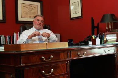 Lawyer joel hamner meets with a client to discuss a hotel accident exhibit highlighting unsafe conditions.
