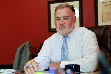 Lawyer joel hamner meets with a client to discuss a reckless driving exhibit showing speed evidence.