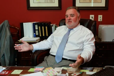 Lawyer joel hamner meets with a client to review a doordash accident exhibit featuring delivery logs.